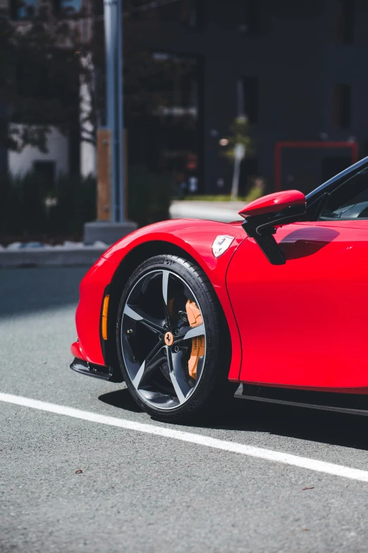 red sports car in street near light post