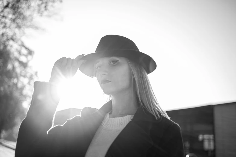 woman posing for the camera wearing a black hat