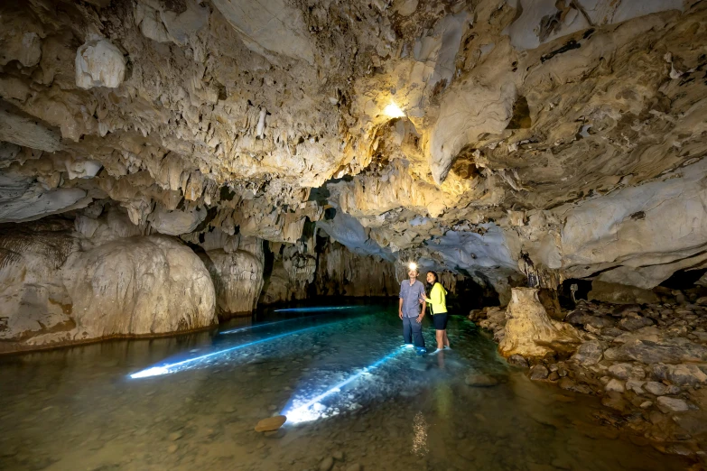 two people standing in an underground area with lights