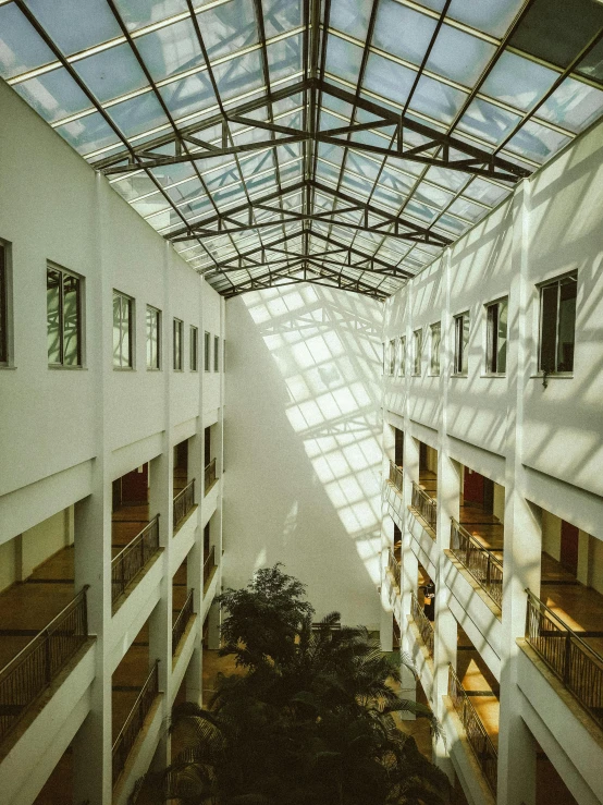 a large atrium that has a roof and windows on the floor