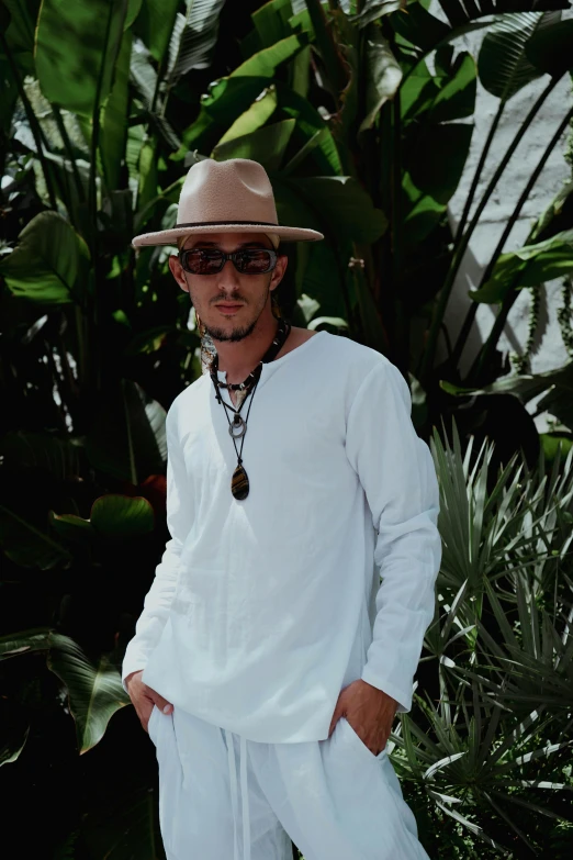 a man wearing a straw hat, sunglasses and a white shirt