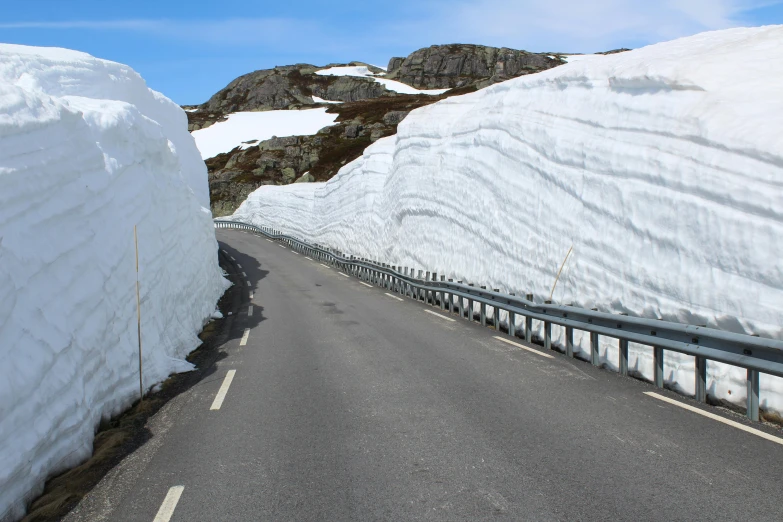 a road is blocked off by snow as it freezes