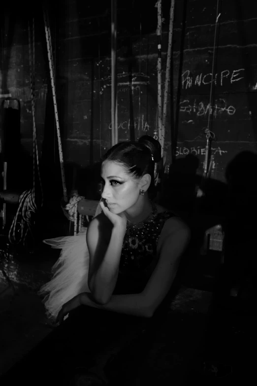 a girl in a dress sitting at a table