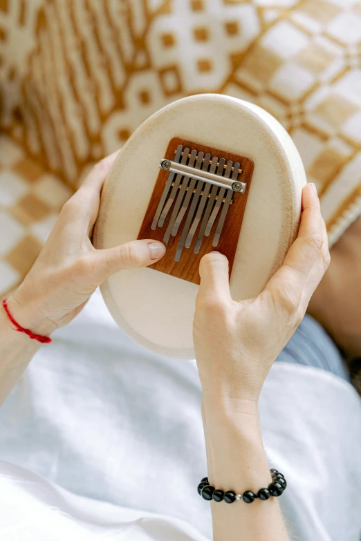 a woman holding a hand comb to her face