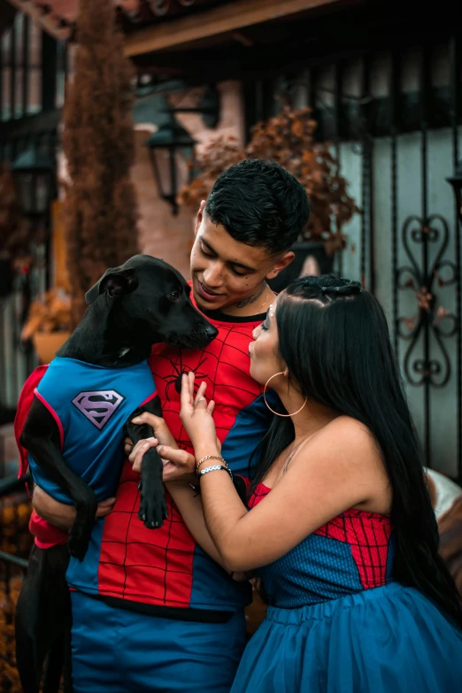 a couple wearing cosplay posing with their dog