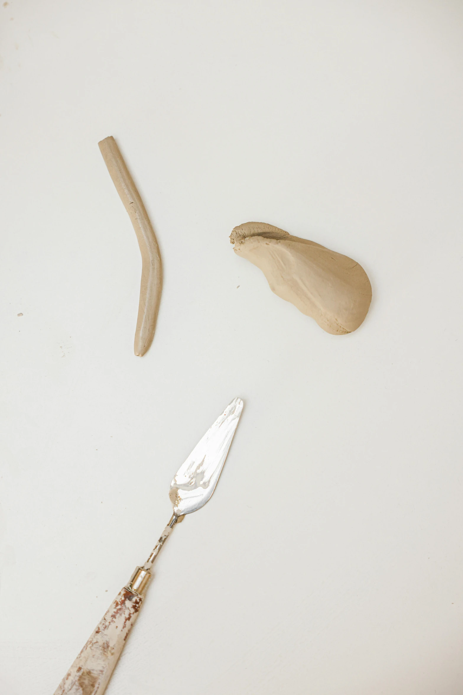 a spoon with a fork and a wooden spoon