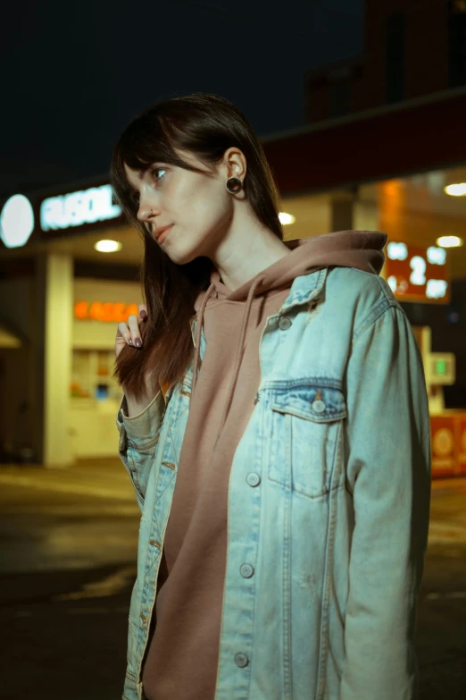 a beautiful woman with blue eyes wearing a jean jacket