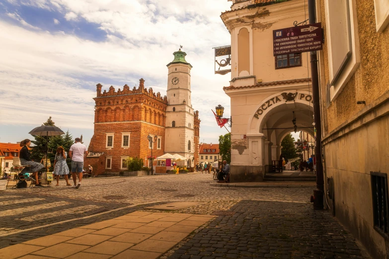 a building with a clock tower in the middle of a town