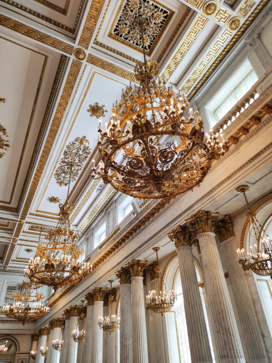 fancy chandeliers line the ceiling of a large room