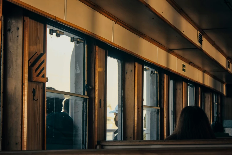 a person looking out the window on a train