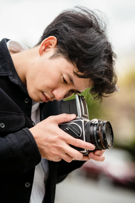 a man holding up his camera to take a picture