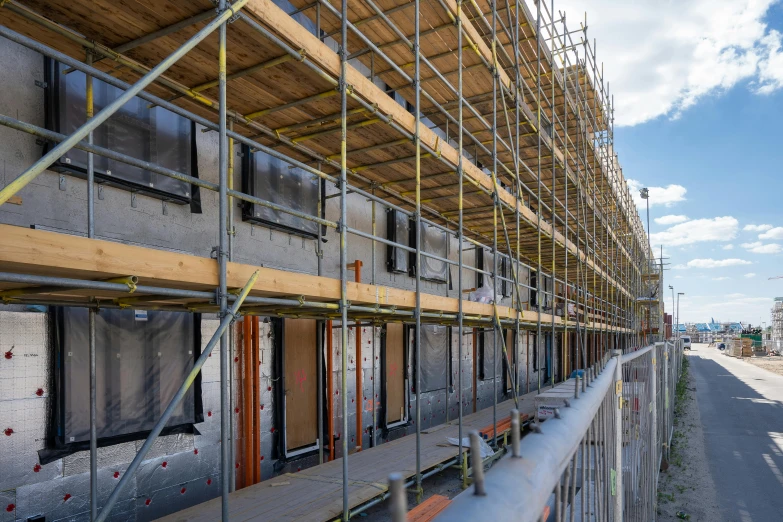 a building with scaffolding and windows in front of it