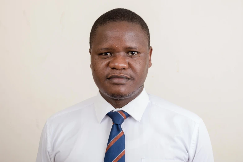 a man in white shirt and tie posing for a picture