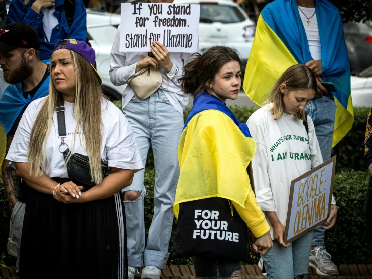 protesters wearing anti - social protest robes and sign with words