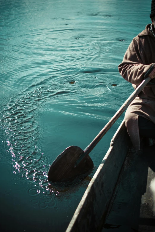 a man rowing a canoe out on the water