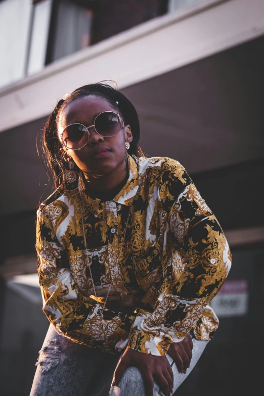 a black woman with sunglasses holding a skateboard