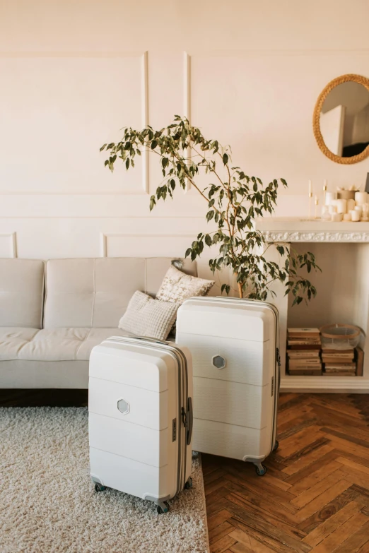 a white couch with two pieces of luggage