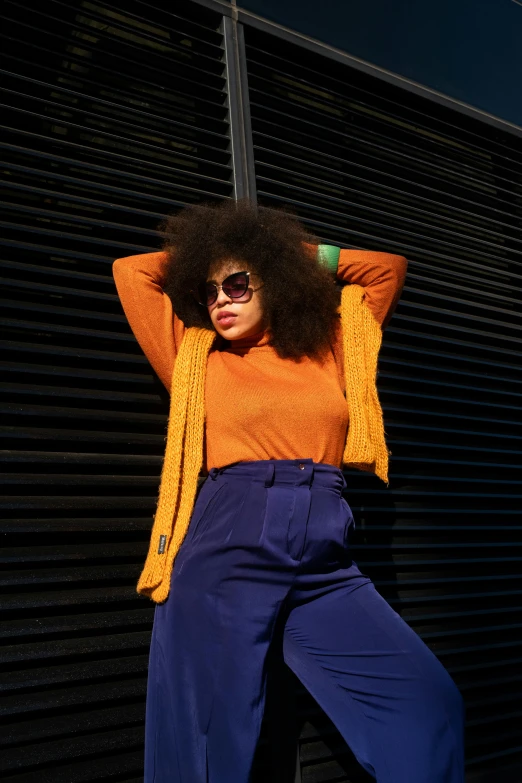 a woman wearing sunglasses is sitting on the ground