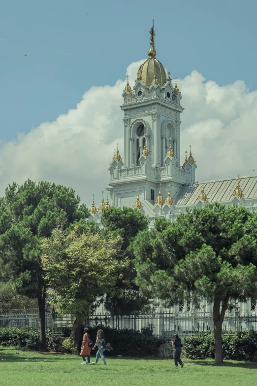 a tall clock tower towering over a lush green park