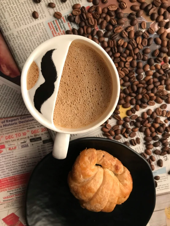 two different shapes of coffee, cinnamon and coffee beans are in the background