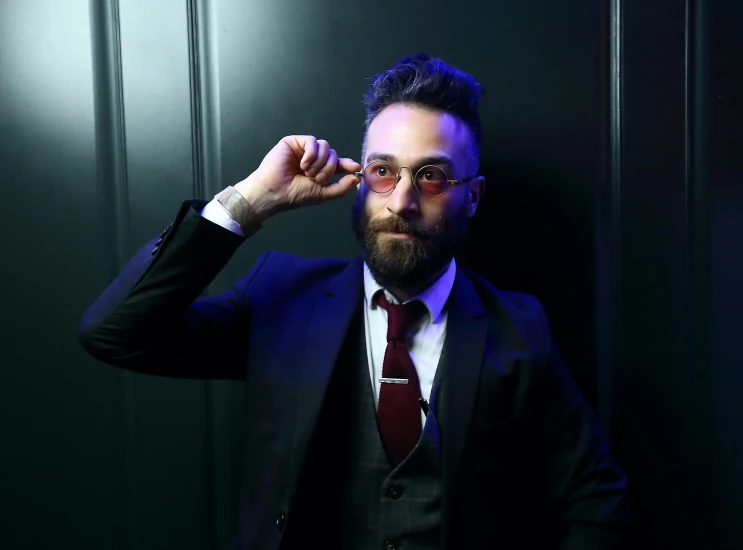 a man posing for the camera in a suit and tie