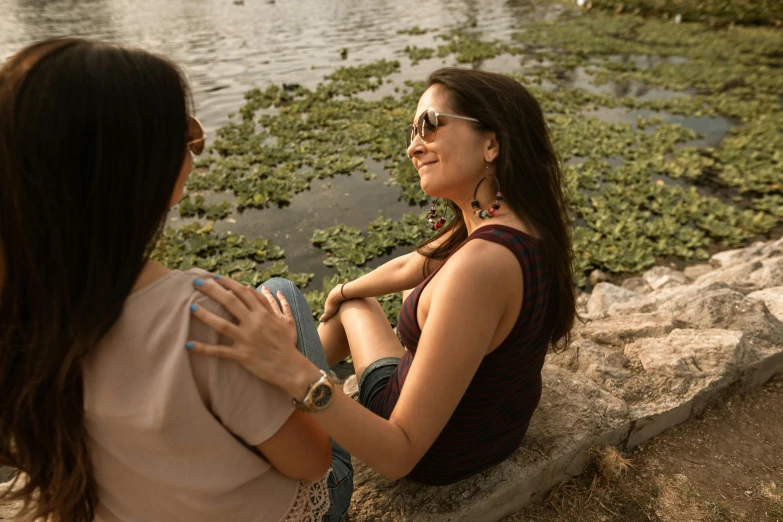 two women standing around looking out over water plants