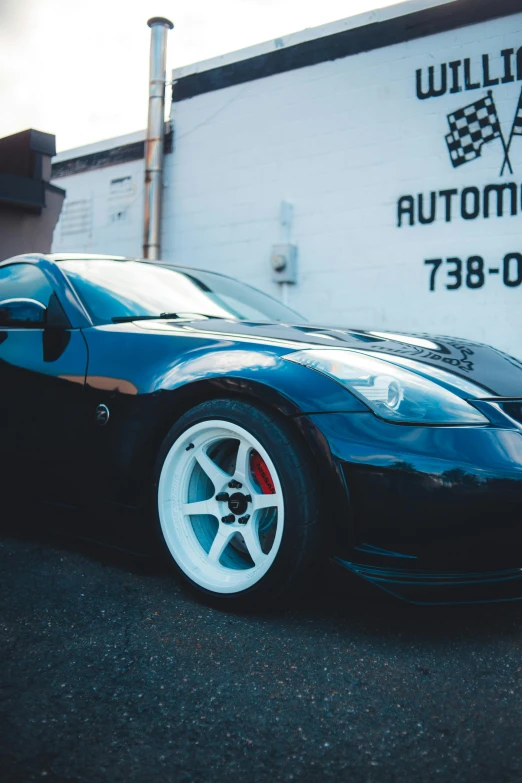 a sports car parked in front of a racing track