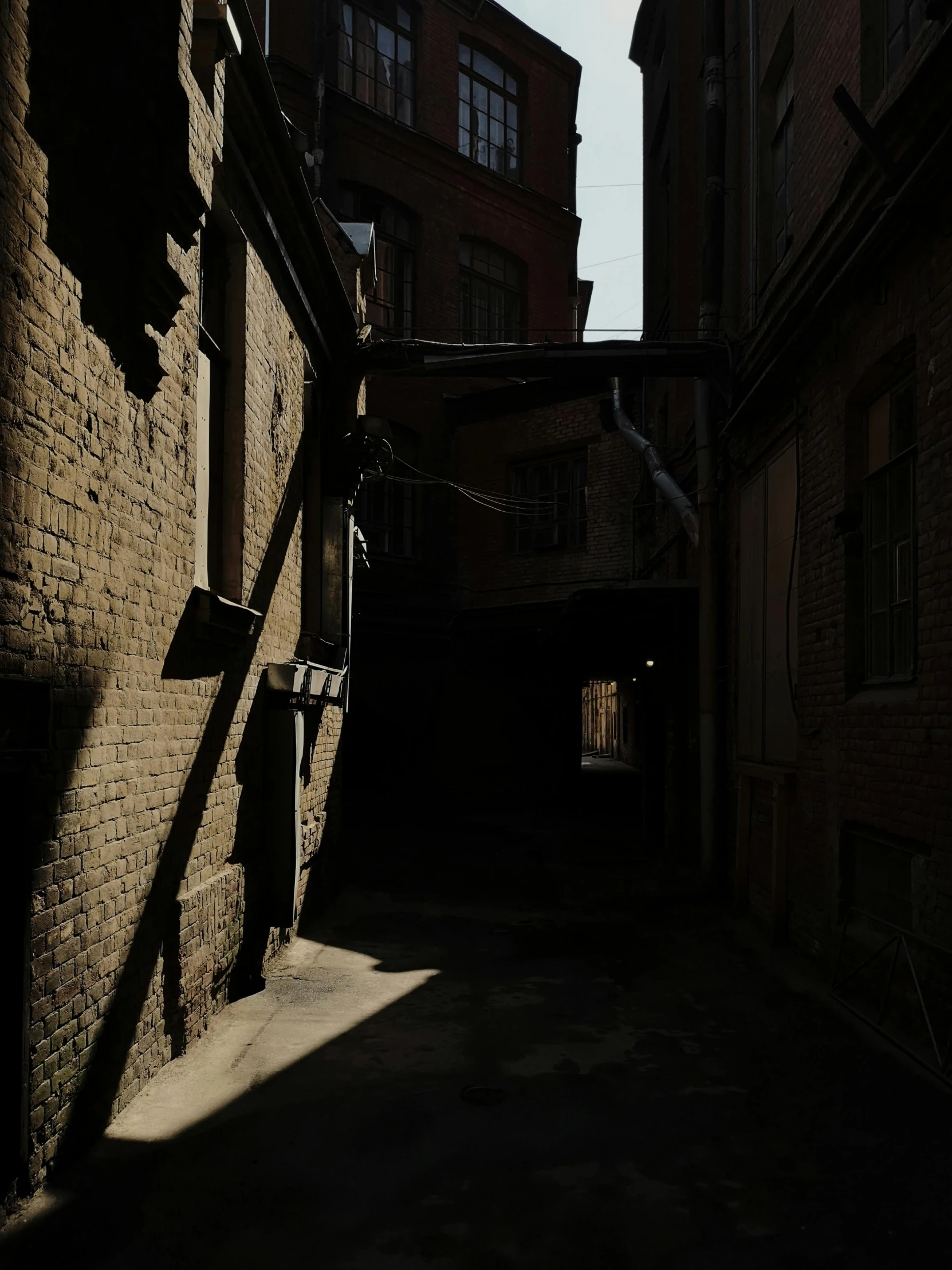 a shadow is cast over a street that houses buildings