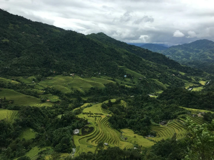 a view looking down at a valley from the top of a hill