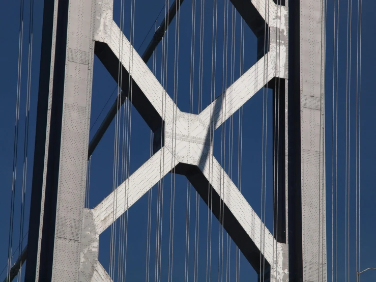 a tall, white, metal bridge spanning over the water