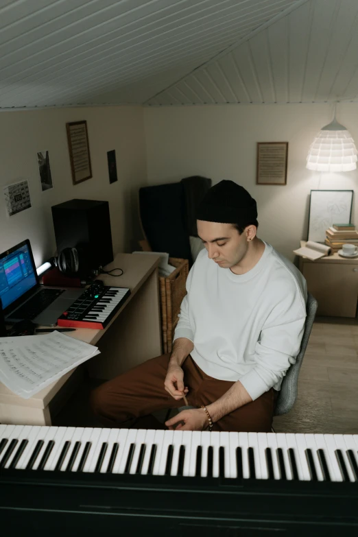 a man that is sitting in front of a keyboard