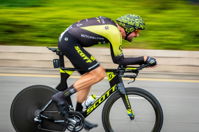 a man in bicycle jersey with helmet on and knee pads