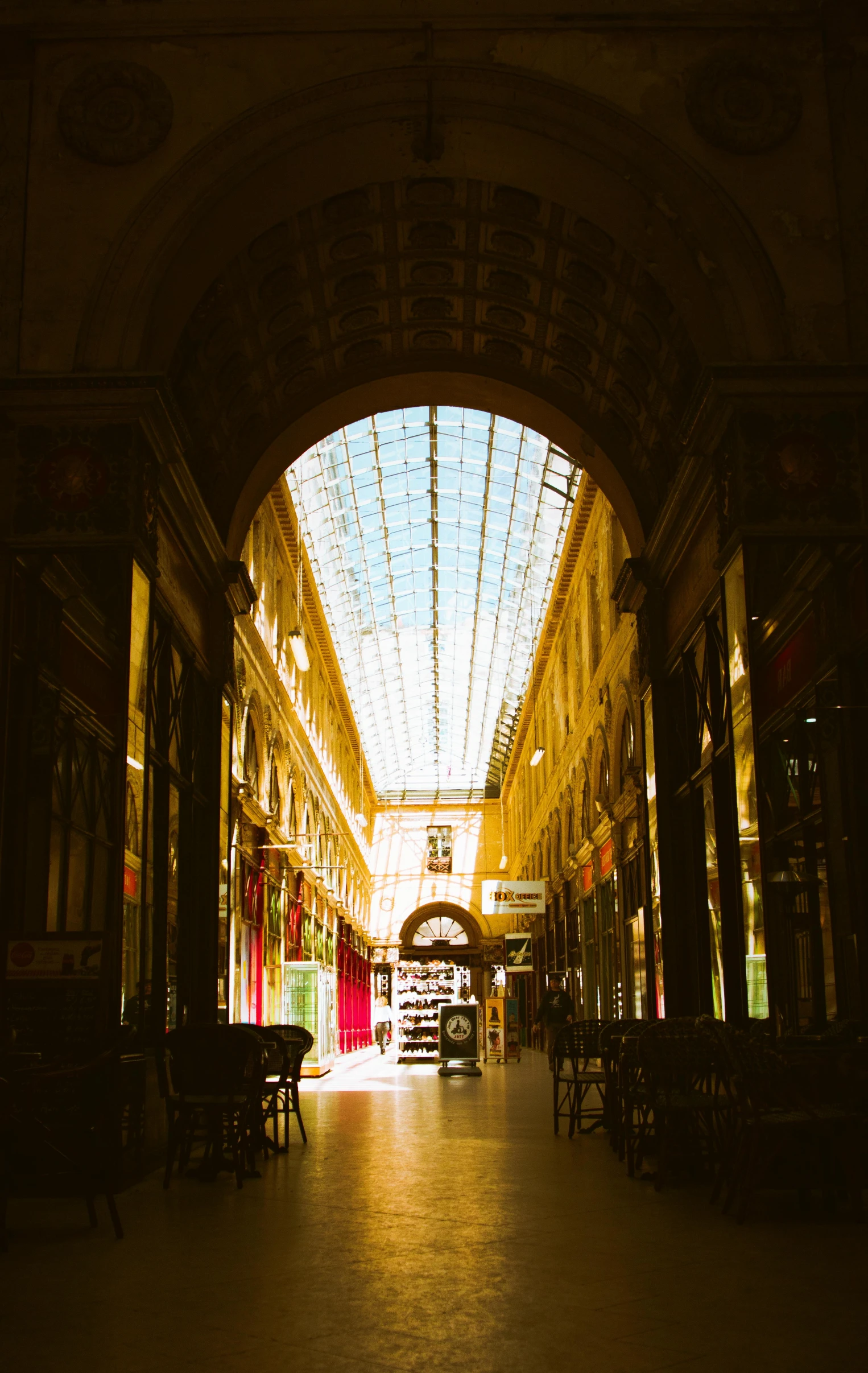 a large indoor mall is lit by a very bright sun