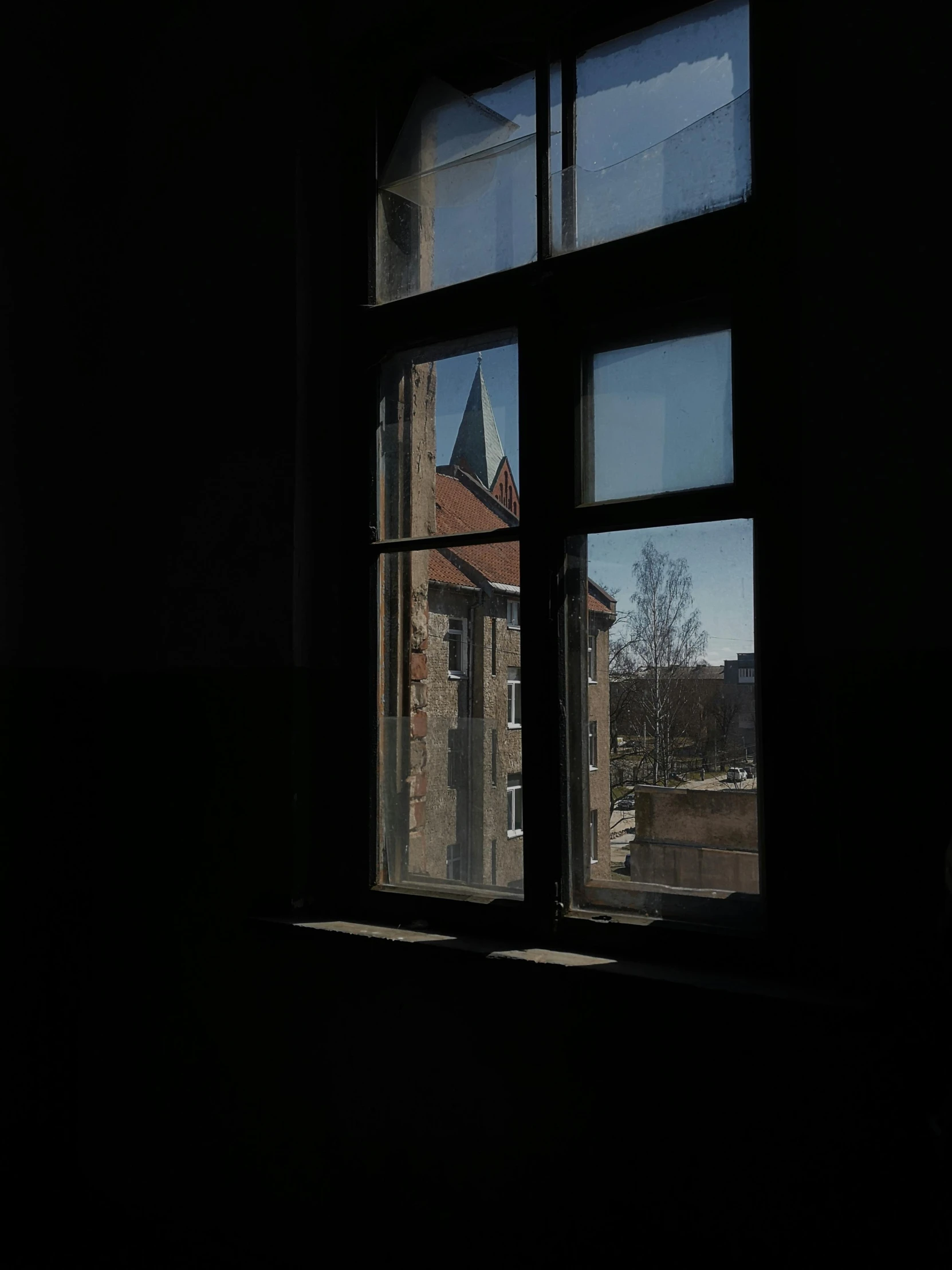 a church tower visible through a window in the dark