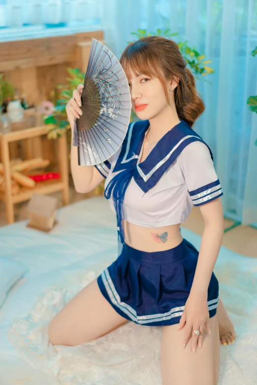 a pretty young lady holding a fan and posing for a camera