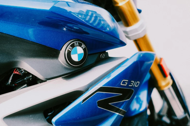 a blue motorcycle with a large shiny emblem on it