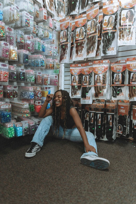 a woman kneeling on the floor next to many cans and cans