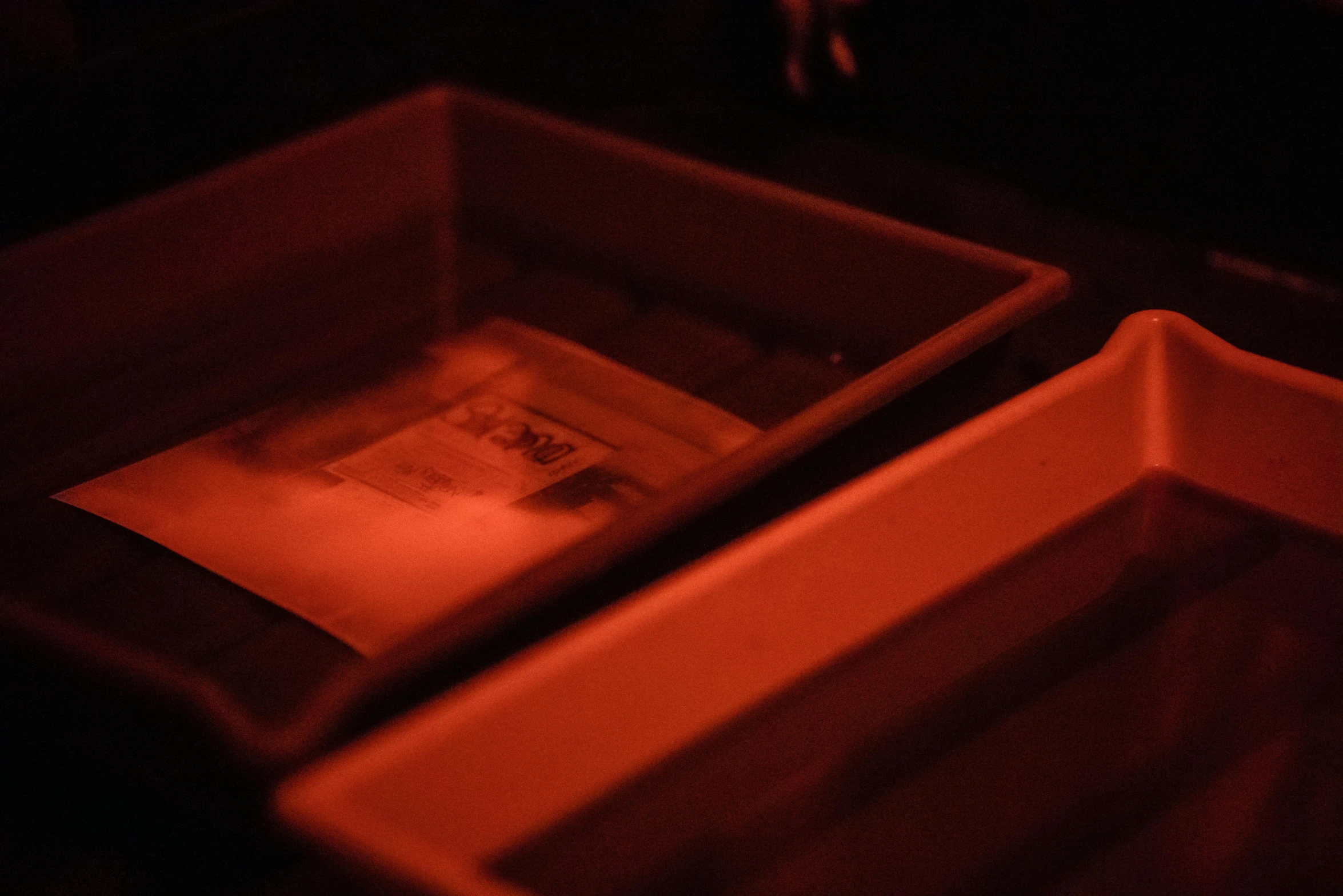 two small square shaped items in a red lit room