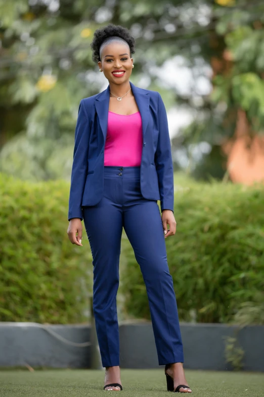 the woman is standing in a bright pink shirt