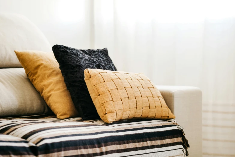 a couch is arranged with a pillow on top