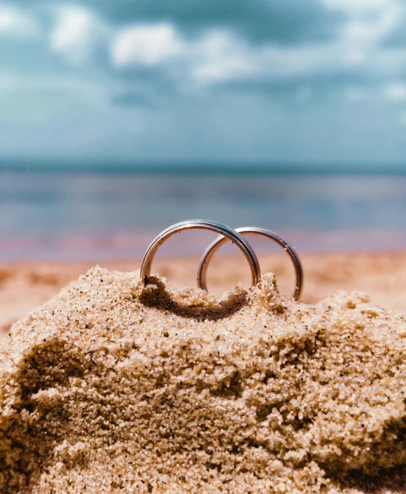 a couple of rings are sticking out of the sand