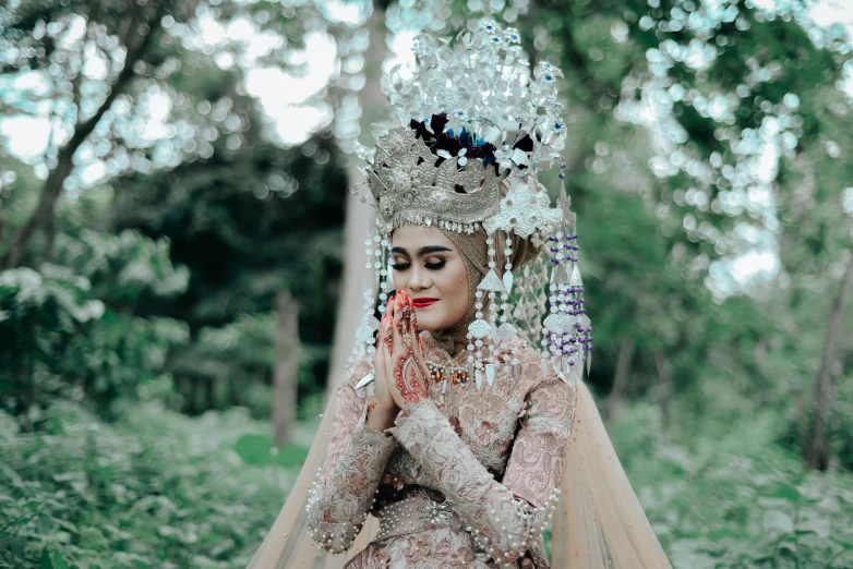 a beautiful indian woman with elaborate jewelry on her head and body