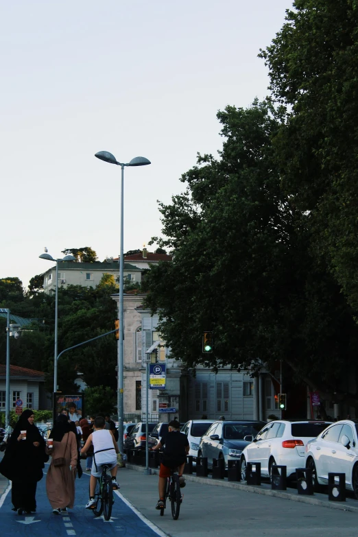 people on bicycles and cars at an intersection