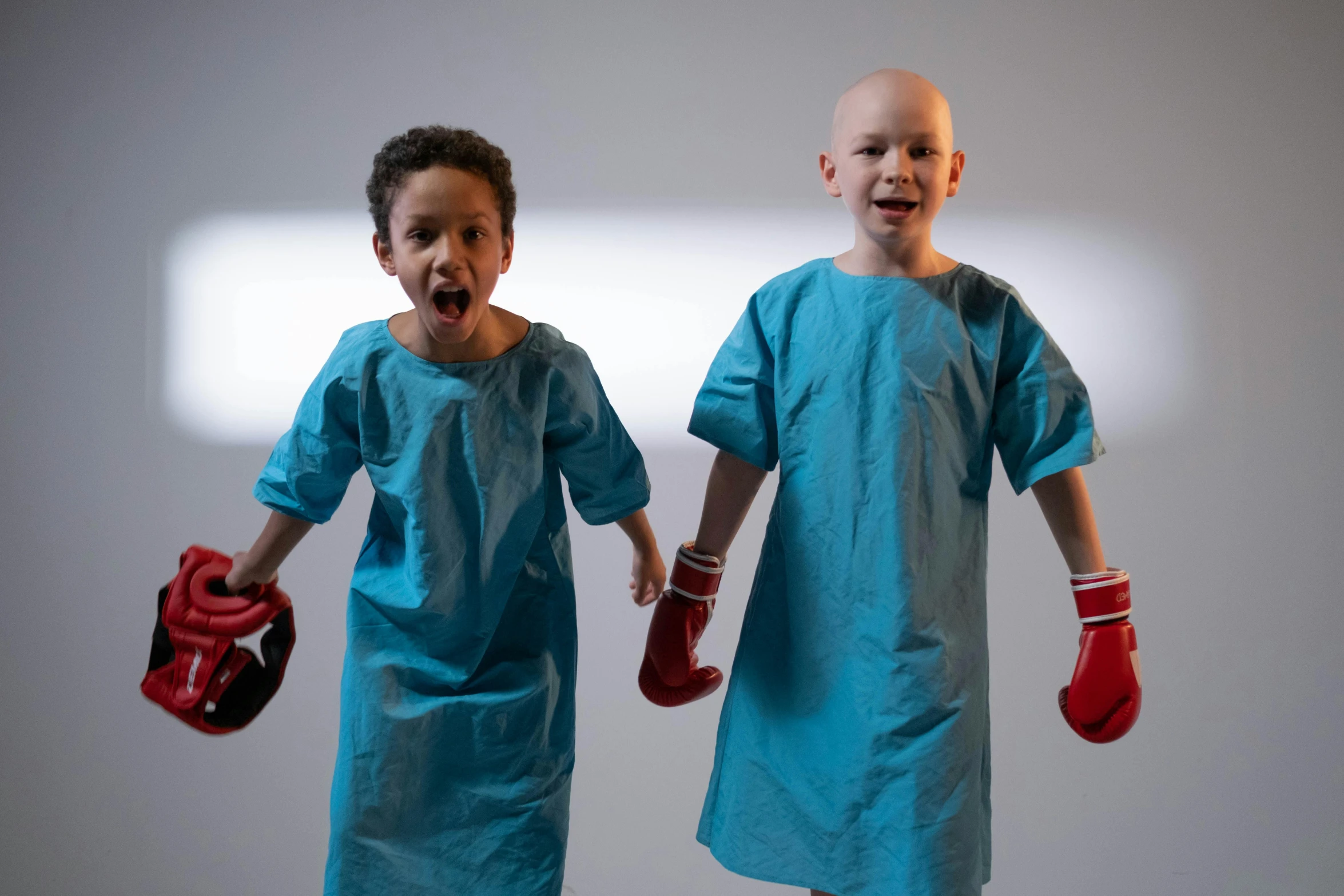 two s wearing boxing gloves posing for a picture