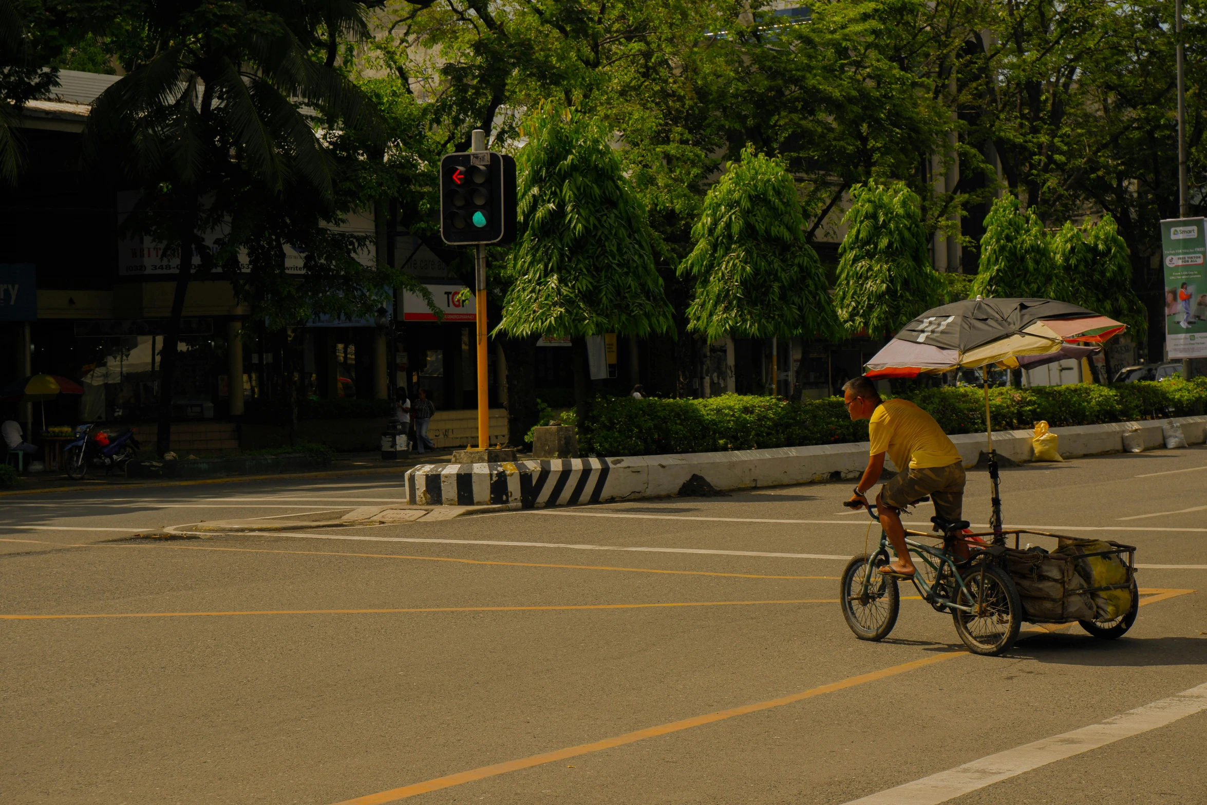 a person with an umbrella on the back of a bicycle