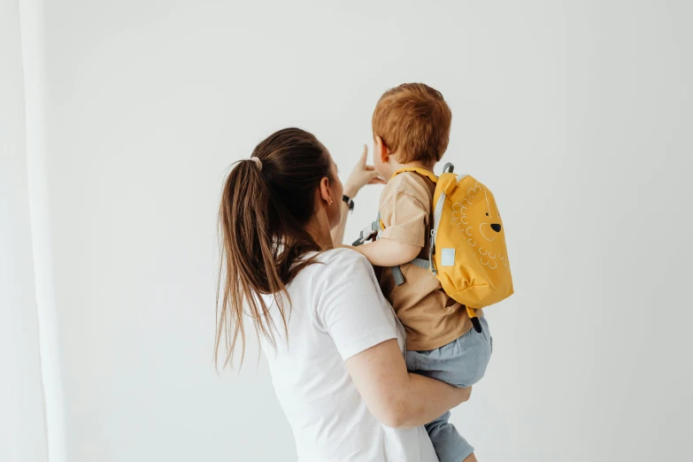 a woman is holding her son in her arms