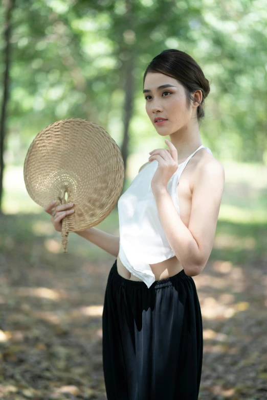 a young woman poses for the camera with an umbrella hat