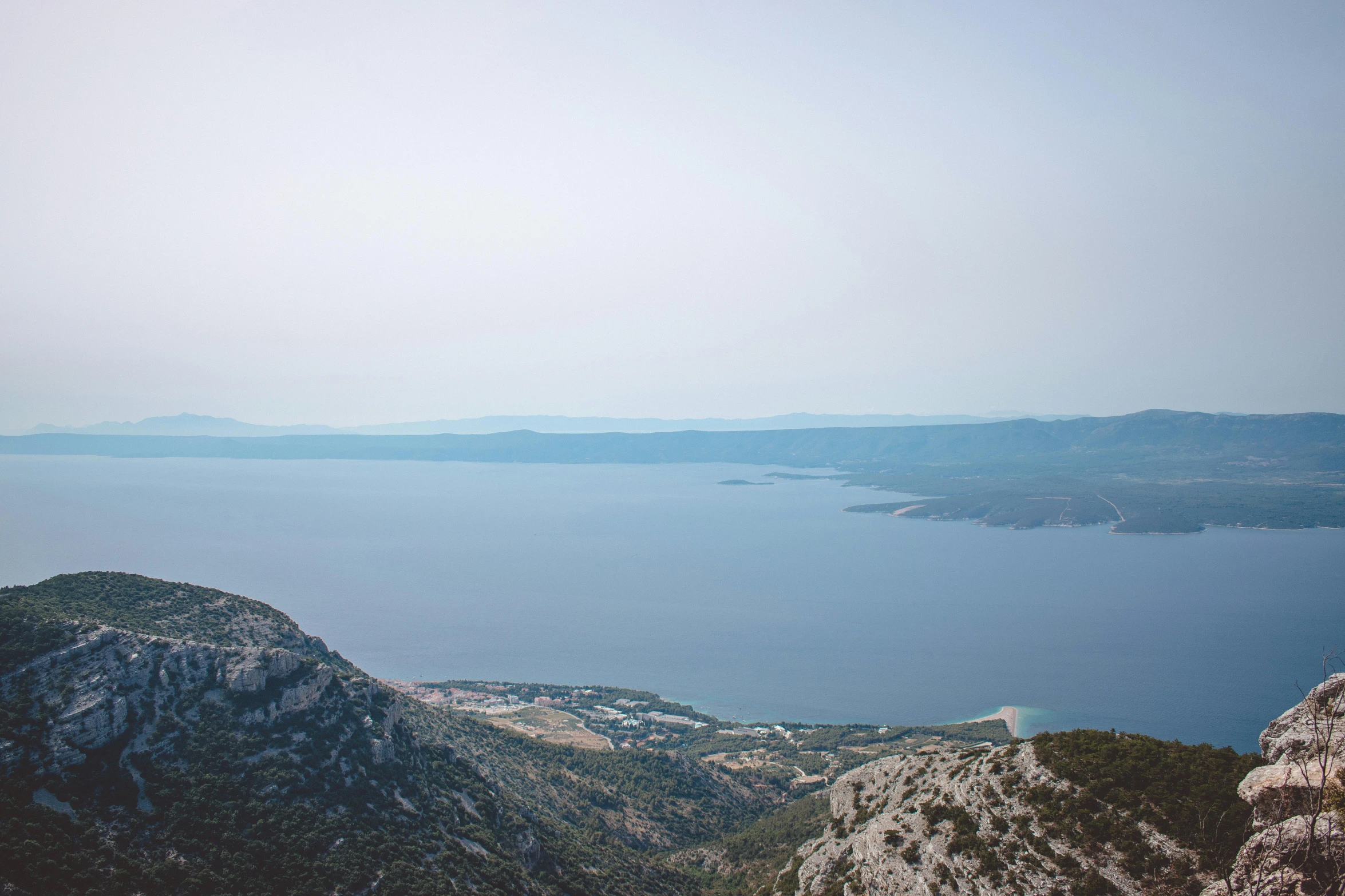 an image of the ocean from high up on a hill