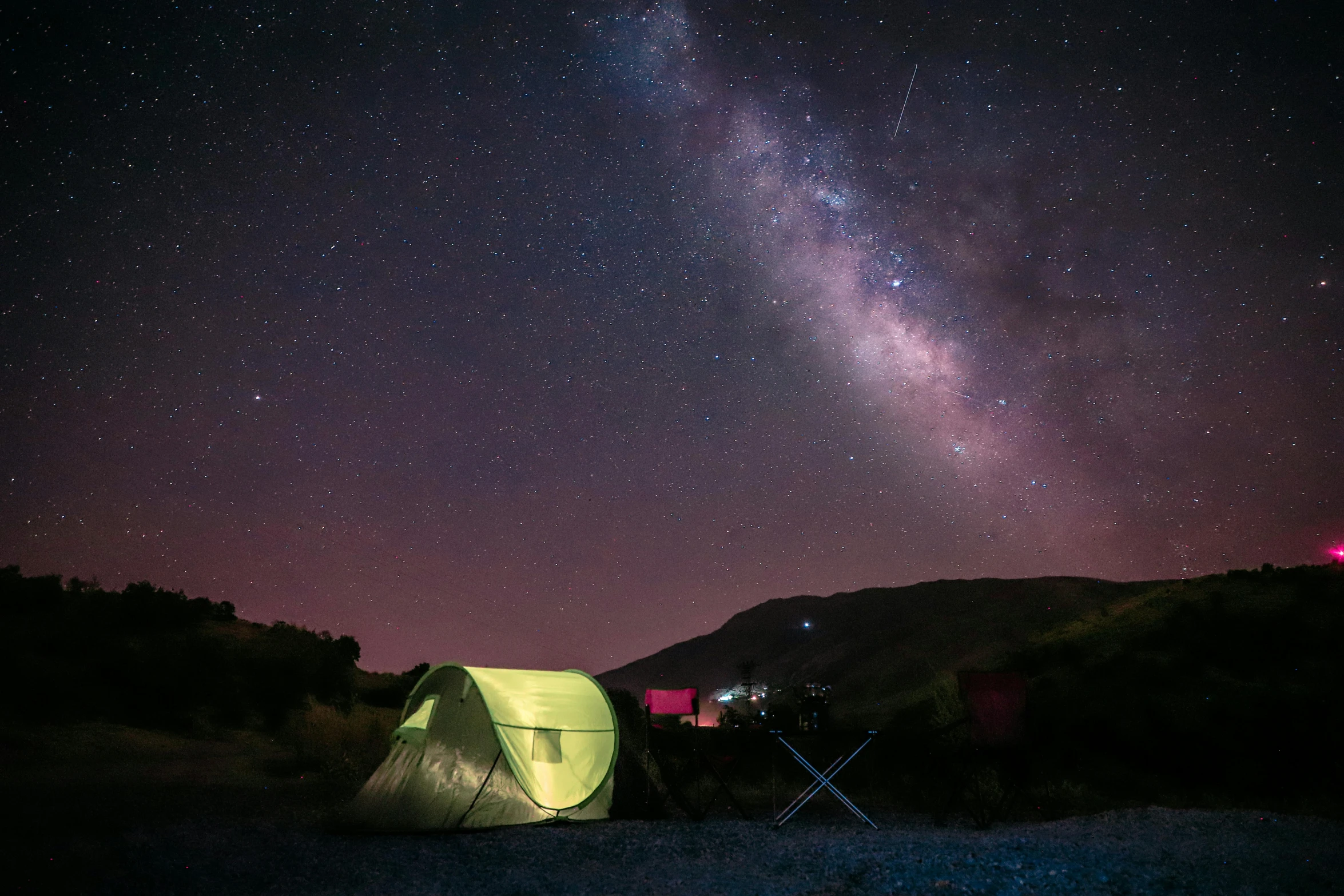 there is a tent in the middle of nowhere under the stars