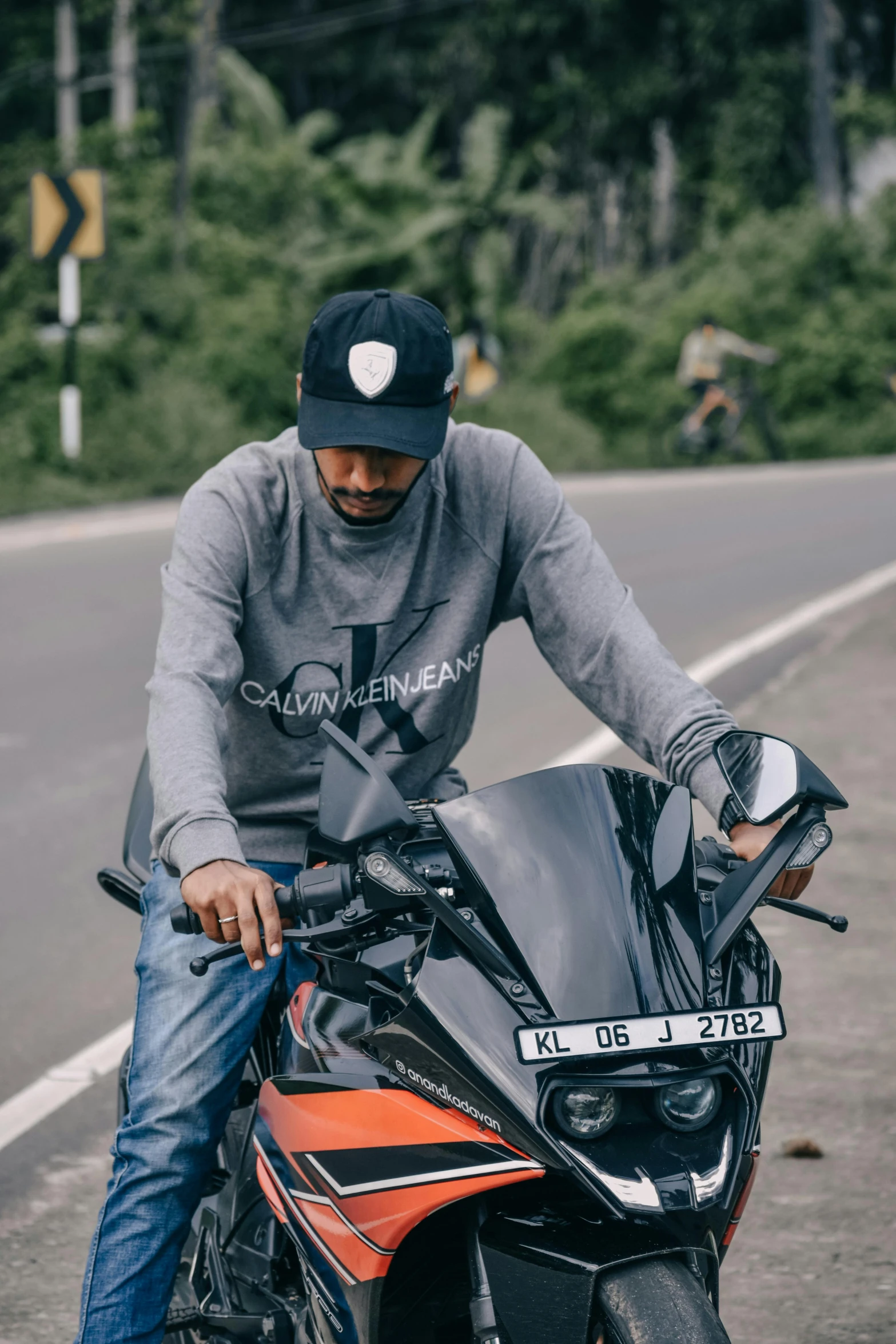 a man sitting on the front of a motorbike